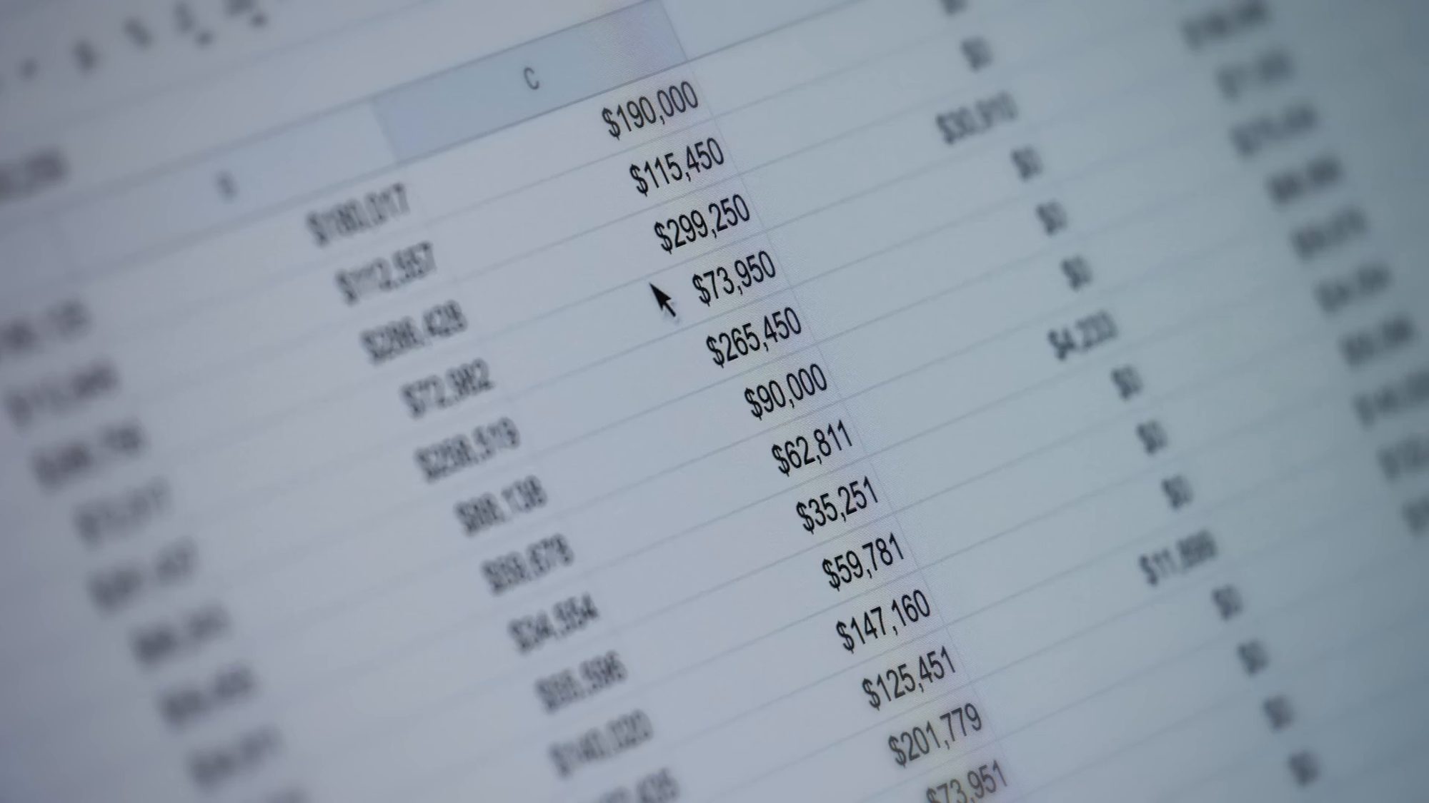 A spreadsheet of financial figures, softly out of focus at the edges