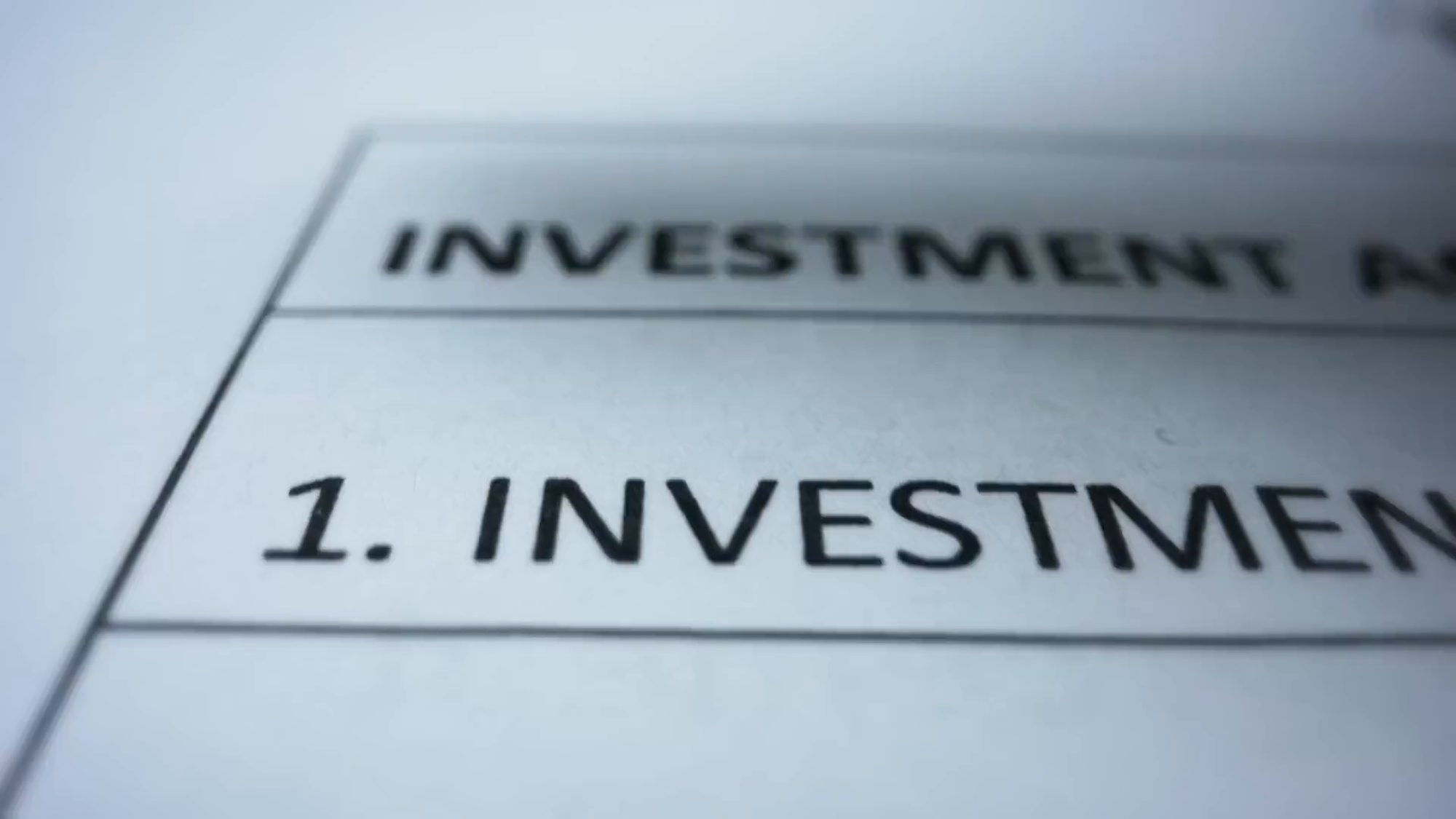 A checklist of deal terms being ticked off in green, softly out of focus at the edges